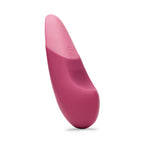A sleek, light green clitoral vibrator with a smooth, ergonomic design.
